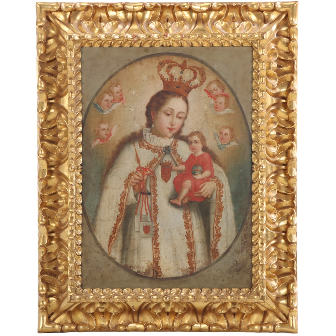 SPANISH COLONIAL MISSIONARY PAINTING "OUR LADY OF MOUNT CARMEL WITH THE CHRIST CHILD AND ANGELS" OIL: Spanish Colonial Missionary painting "Our Lady of Mount Carmel with the Christ Child and Angels" oil on canvas c. 18th-19th century Housed in later Italian carved gilt frame. Interior (sight)- Ht: 18"