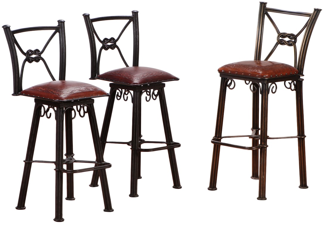 TWO SWIVEL AND ONE FIXED IRON AND EMBOSSED LEATHER BAR STOOLS. (1 of 9)