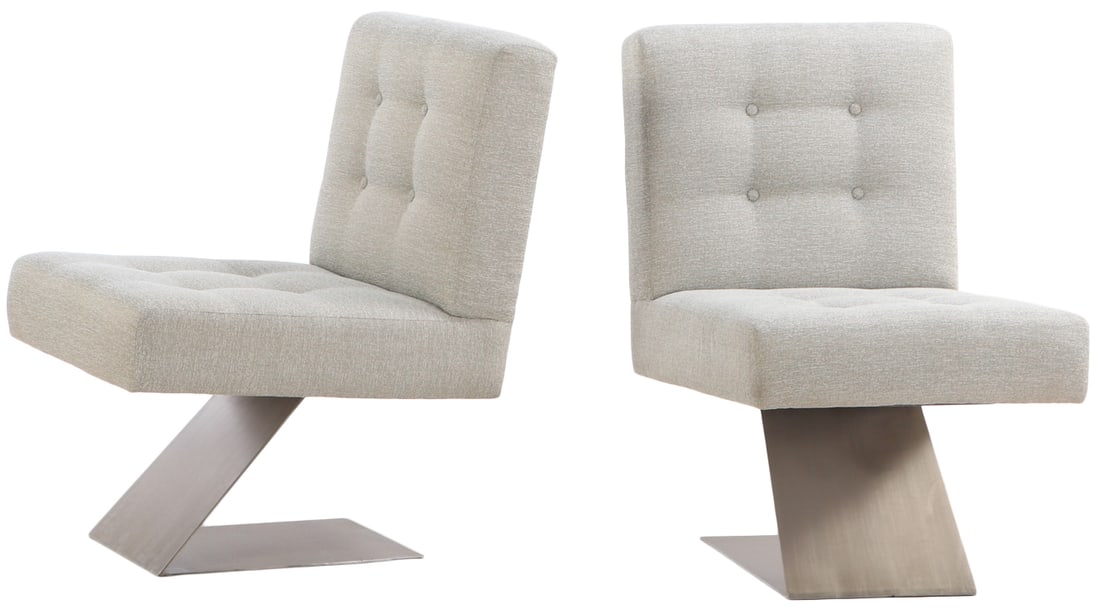 PAIR OF BUTTON BACK UPHOLSTERED LOUNGE CHAIRS RESTING ON STAINLESS STEEL BASES.: Pair of button back upholstered lounge chairs resting on stainless steel bases. Ht: 37" Wd: 24" Dpth: 32" Seat: 20"