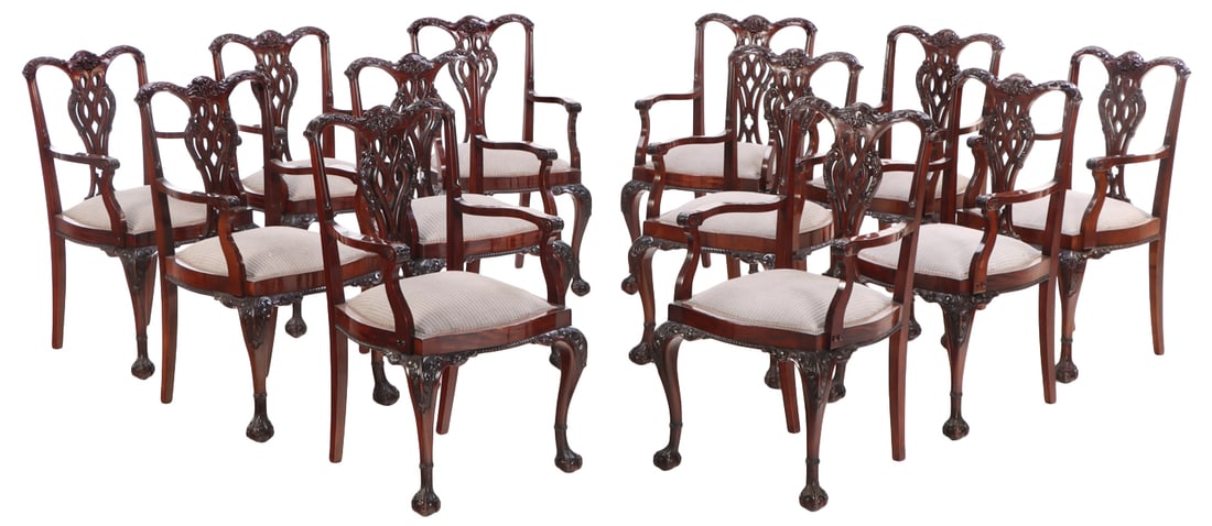 RARE SET OF TWELVE ENGLISH MAHOGANY CHIPPENDALE ARM CHAIRS C 1900.: Rare set of twelve English mahogany Chippendale arm chairs C 1900. While the chairs appear to be identical six chairs weigh less than the others. Ht: 38.5" Wd: 23" Dpth: 22.5" Seat: 21"