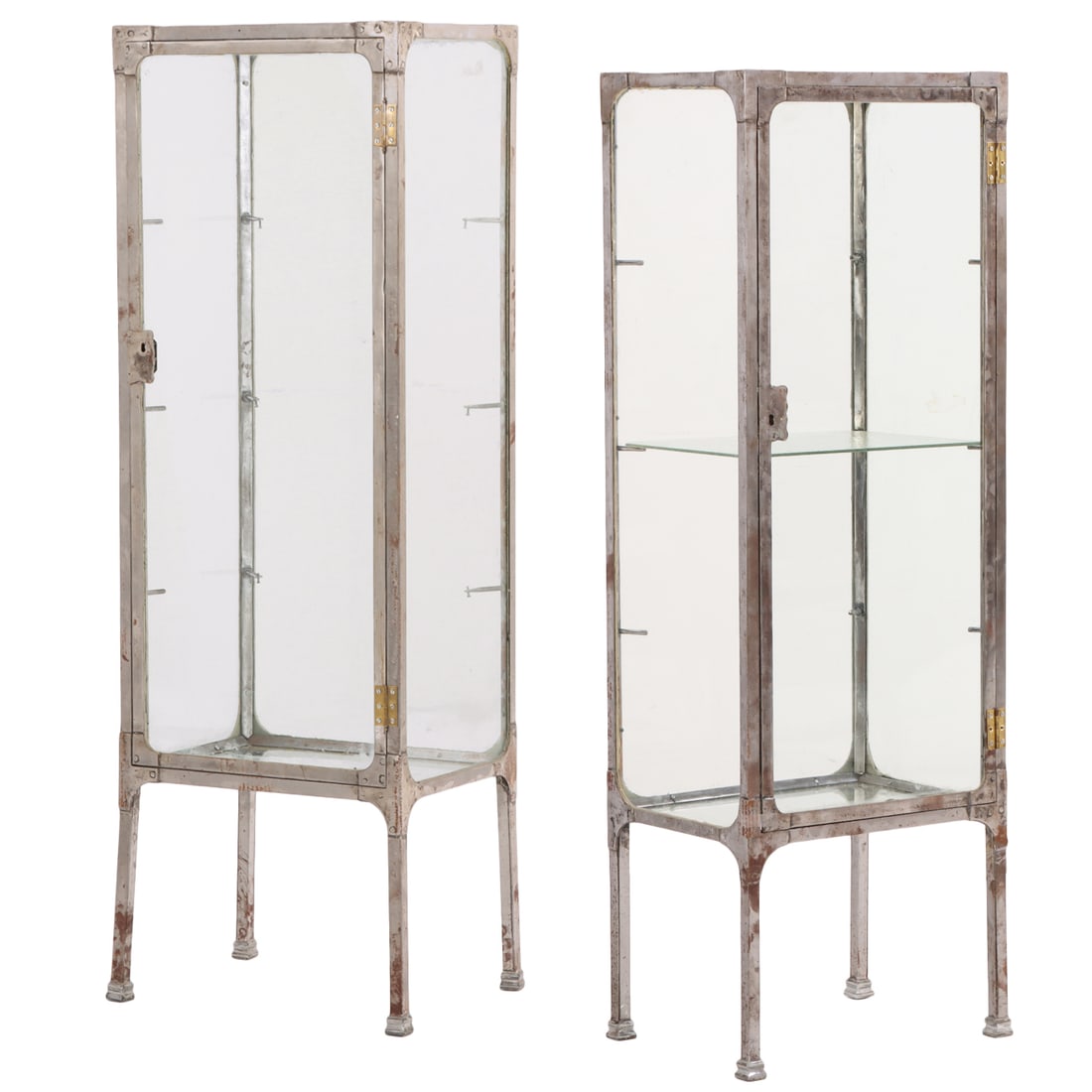 A SMALL PAIR OF SINGLE DOOR CHROME OVER IRON VITRINES HAVING GLASS ON ALL SIDES C 1925.: A small pair of single door chrome over iron vitrines having glass on all sides C 1925. Ht: 59.5" Wd: 19.5" Dpth: 15"