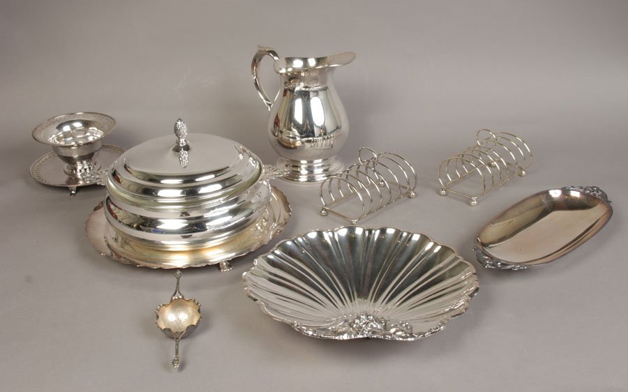 9PC COLLECTION SILVERPLATE ITEMS PITCHER BREAD: A clean nine piece collection of silverplate items for the table circa 1950. Including a casserole, a 12" footed server, a pitcher, large shell dish, a Danish bread tray, two toaster racks, a gravy bo
