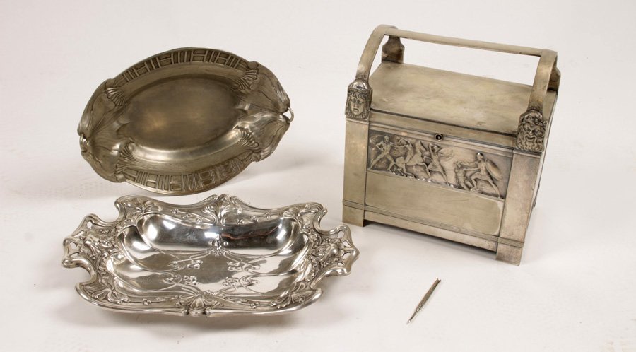 ART DECO WMF CASKET 2 NOUVEAU BREAD TRAYS: Handsome Art Deco/Nouveau three piece metalware lot to include a Deco WMF casket with handle, and two Art Nouveau bread trays circa 1920. Ht: 10.5" Width: 9.5" Depth: 6" (casket)