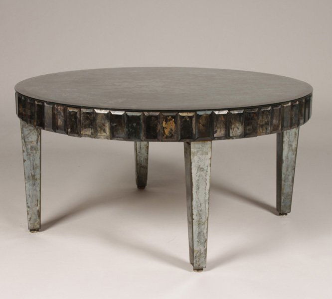 REGENCY STYLE ROUND MIRRORED COFFEE TABLE: Hollywood Regency style round mirrored coffee table circa 1950. The top having smoked mirror and the apron comprised of beveled mirrored rectangles. Ht: 18" Width: 36" Depth: 36"