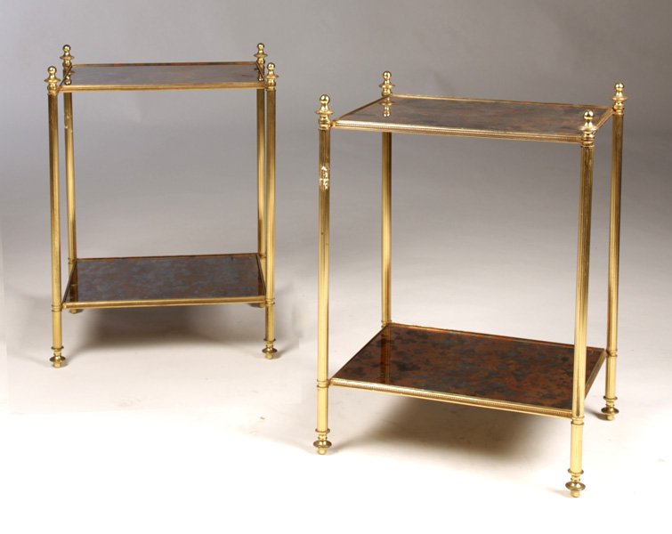 PR BRASS 2 TIERED END TABLES DISTRESSED COPPER: A pair of brass two-tiered end tables having distressed copper mirrored top and lower shelf circa 1970. Ensuite with the previous lot. Ht: 21" Width: 15.5" Depth: 12.75"