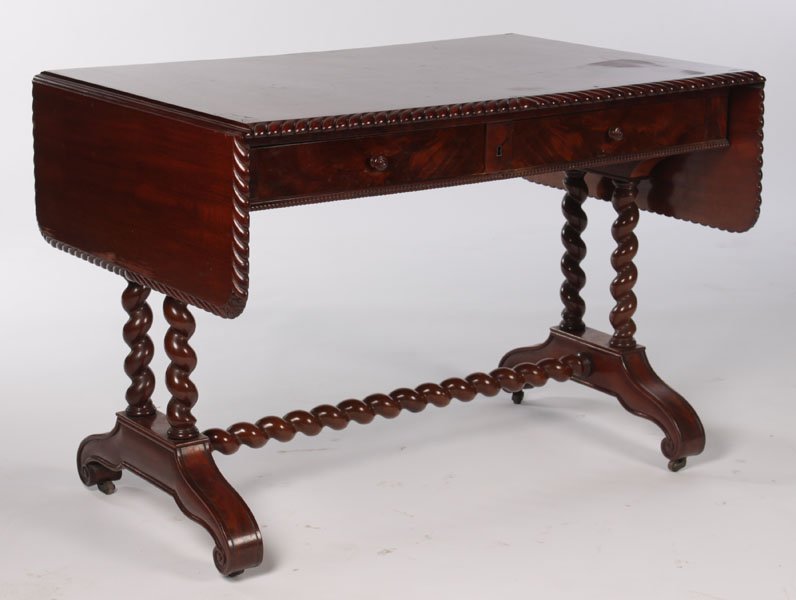 CHARLES X STYLE CARVED MAHOGANY SOFA TABLE: A Charles X style carved mahogany sofa table having rope twist edge and drop sides over two drawers circa 1880. Supported on barley twist legs and stretcher. Two drop leaves, each measuring 11". Ht: 2