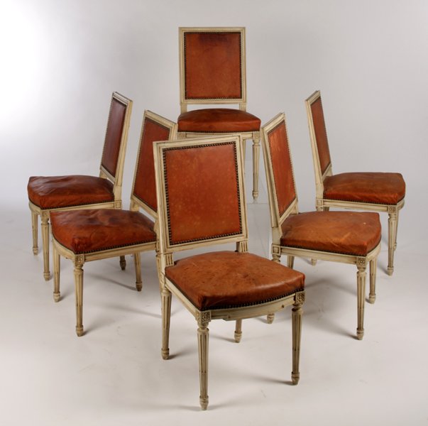 SET 6 LOUIS XVI STYLE LEATHER DINING CHAIRS: A good set of six Louis XVI style painted leather dining chairs having tailored back and shaped seat with nailhead decoration circa 1920. Supported on turned and fluted legs. Ht: 36" Width: 18" Depth: