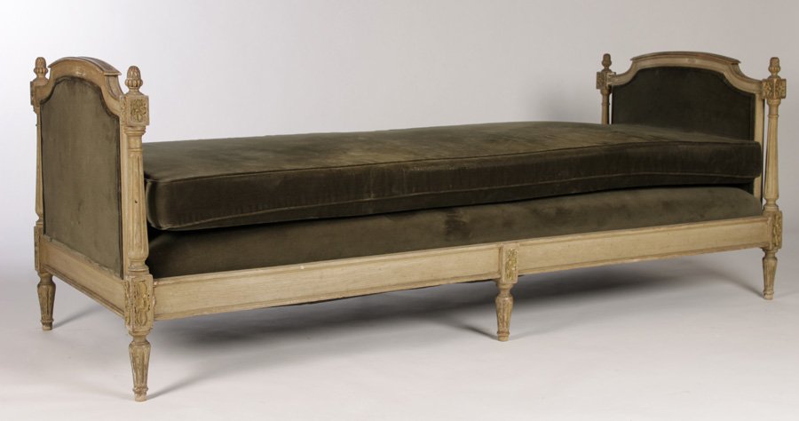 LOUIS XVI CARVED PAINTED DAYBED UPHOLSTERED ENDS: A Louis XVI style carved and painted daybed having acorn finials and fluted column decorated upholstered ends circa 1920. Ht: 29" Width: 78.5" Depth: 31.5"
