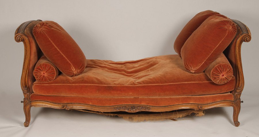 LOUIS XV CARVED WALNUT UPHOLSTERED DAYBED: A Louis XV style carved walnut and upholstered daybed having scrolling ends and cabriole legs circa 1920. To include cushions and mattress. Ht: 32.5" Width: 72" Depth: 33"