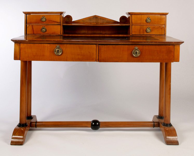 BIEDERMEIER DESK 4 DRAWERS LEATHER TOP: A biedermeier neoclassical desk having central pediment flanked by four drawers and inset leather top and two drawers circa 1840. Supported on column form legs with ebonized trim. Ht: 39" Width: 49.5"