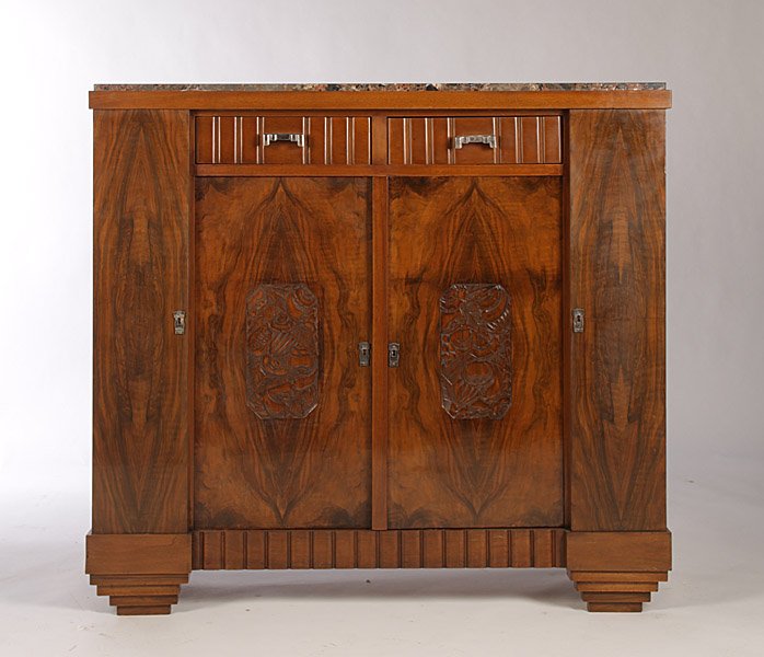 FRENCH ART DECO SERVER C. 1930: French Art Deco server having inset marble top over two drawers and two doors having central carved panels raised on stepped feet circa 1930. Dimensions: Ht: 43.5" Width: 47.5" Depth: 18"