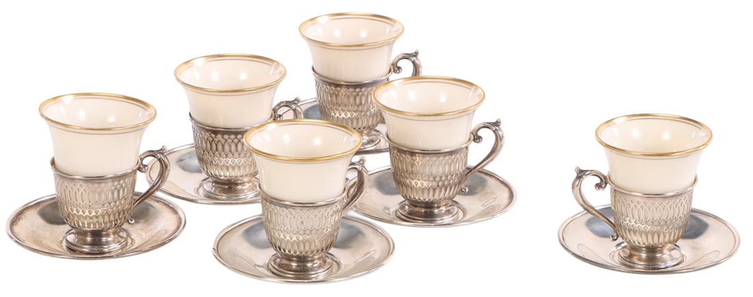 12 PC WHITING STERLING SILVER DEMITASSE CUPS AND SAUCERS WITH LENOX PORCELAIN INSERTS, SERVICE FOR: 12 pc Whiting sterling silver demitasse cups and saucers with Lenox porcelain inserts, service for six c 20th century includes Cartier boxes. Total weight: 8.55 troy oz. Ht: 3" Wd: 3.75" Dpth: 3.75"