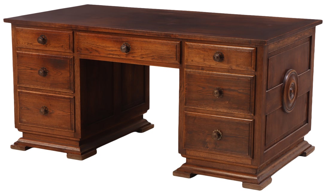 A LARGE FRENCH OAK DOUBLE PEDESTAL DESK IN THE MANNER OF CHARLES DUDOUT C 1940 HAVING A NICELY: A large French oak double pedestal desk in the manner of Charles Dudout C 1940 having a nicely finished back panel. Kneehole measuring a height of 22.25". Ht: 29.75" Wd: 61" Dpth: 34.5"