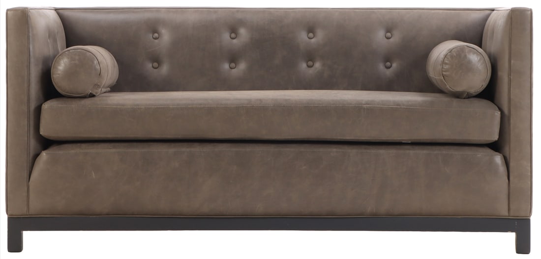A TAILORED EVEN ARM LEATHER SOFA HAVING BUTTON BACK UPHOLSTERY AND TWO BOLSTER CUSHIONS. (1 of 6)