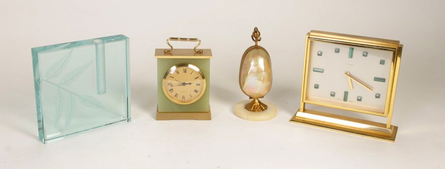 4 PIECE LOT OF 2 DESK CLOCKS, WATCH & GLASS VASE: Eclectic four piece lot of two elegant desk clocks, a watch and watch case, and a modern glass vase. Consisting of (1)Swiss for FJ Cooper clock 5.25" x 5.87" x 2" (2) Swiss onyx and brass carriage sty