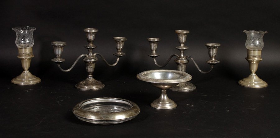 GROUPING OF 5 STERLING SILVER ITEMS CIRCA 1940: A grouping of five sterling silver items to include footed candy dish, nut dish, and three pairs of candelabra circa 1940. Ht: 7" Width: 10" Depth: 3" (largest)