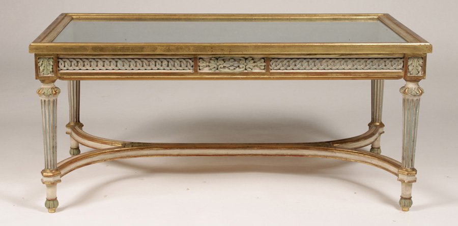 LOUIS XV GILTWOOD CARVED PAINTED COFFEE TABLE: A Louis XVI style giltwood carved and painted coffee table/vitrine having glass topped shadow box circa 1950. Supported on fluted legs with shaped stretcher. Ht: 18" Width: 39.5" Depth: 21"