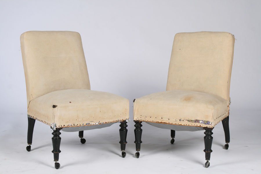 PAIR OF NAPOLEON III SLIPPER CHAIRS CIRCA 1900: A pair of Napoleon III slipper chairs supported on turned legs with casters, circa 1900. Ht: 33.5" Width: 21" Depth: 20"