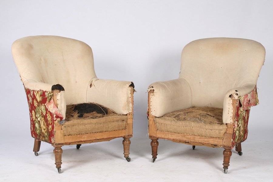 PAIR OF NAPOLEON III CLUB CHAIRS CIRCA 1910: A pair of Napoleon III club chairs having arched back and tailored arms supported on turned legs, circa 1910. Ht: 36" Width: 25" Depth: 26"