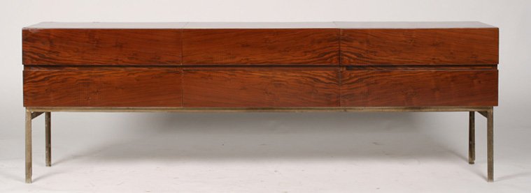 MID CENTURY CREDENZA WITH FIVE DRAWERS CIRCA 1960: Mid Century credenza having central lidded compartment surrounded by five drawers resting on metal legs circa 1960. The veneer is bookmatched throughout. Ht: 23.75" Width: 71" Depth: 15"