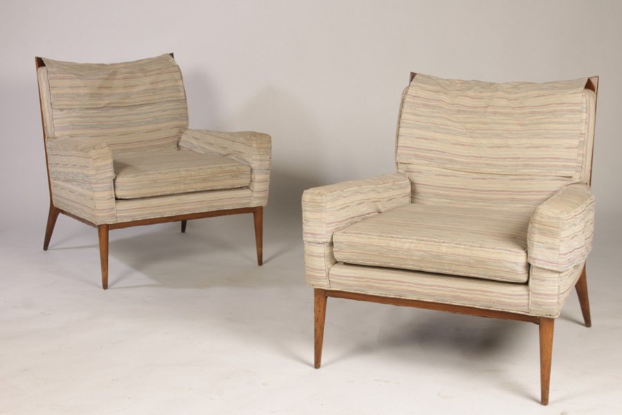 PAIR OF PAUL MCCOBB UPHOLSTERED LOUNGE CHAIRS: A pair of Paul McCobb upholstered lounge chairs having downswept crest rail and tailored arms over loose cushion, circa 1960. Raised on turned and tapered legs. Ht: 32.5" Width: 29" Depth: 29"