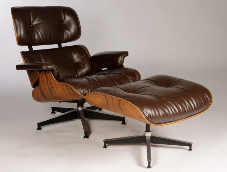 LABELED EAMES HERMAN MILLER 670/671 CHAIR OTTOMAN: A Charles and Ray Eames for Herman Miller labeled 670 lounge chair and 671 ottoman having rosewood plywood, leather, aluminum, and rubber. Ht: 33" Width: 33.5" Depth: 31"