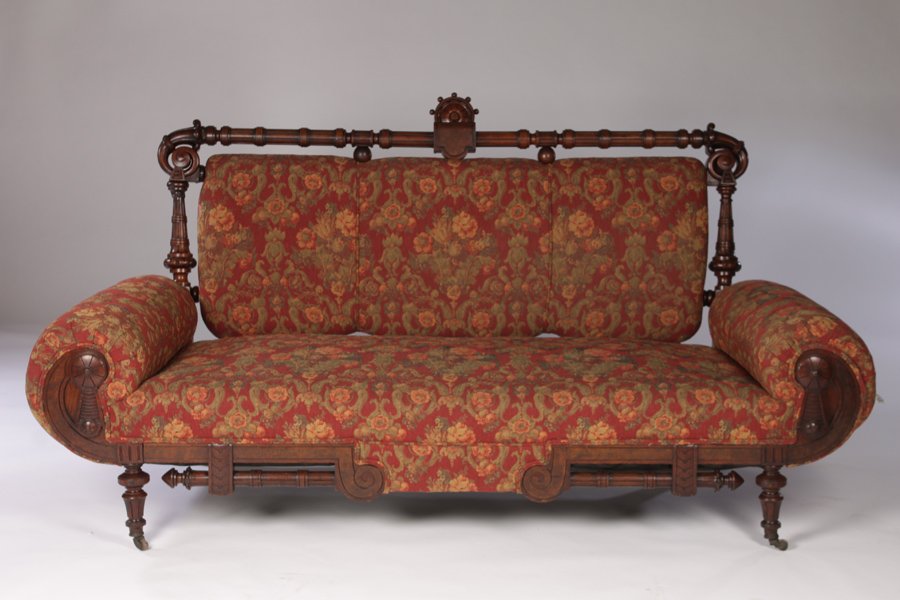 WALNUT RENAISSANCE REVIVAL SOFA CIRCA 1880: A Renaissance Revival walnut Victorian sofa having bolster arms circa 1880. Ht: 76" Width: 41" Depth: 31"