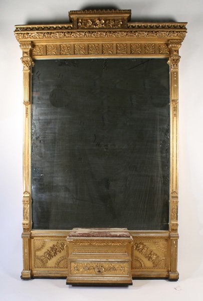 MONUMENTAL VICTORIAN GILT WOOD & GESSO CARVED MIRROR: A monumental American Victorian gilt wood and gesso carved mirror circa 1870. Having ornate stepped cornice and fluted pilasters framed large mirrored central plate over marble top plinth flanked by A