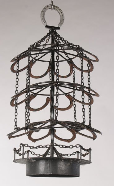 HORSESHOE FORM IRON WINE RACK BIRD FEEDER: A very cool horseshoe form iron wine rack or bird feeder circa 1950. Ht: 33" Width: 18"