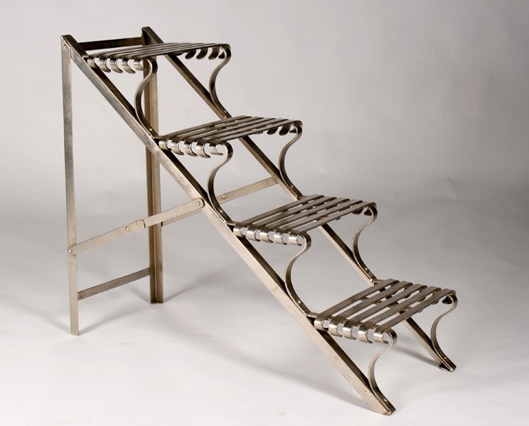 A FOLDING POLISHED METAL 4 STEP LIBRARY LADDER: A folding polished metal four step library ladder. Ht: 34.75" Width: 16.5" Depth: 41"