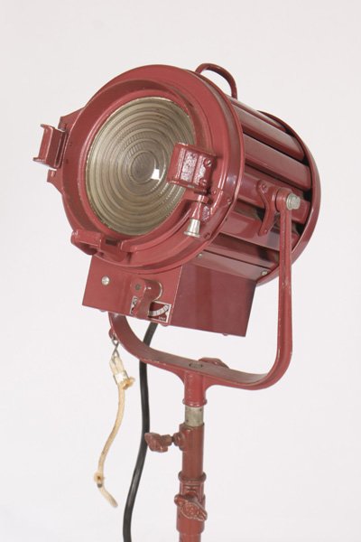 ADJUSTABLE INDUSTRIAL LAMP ON WHEEL BASE C.1950: A fully adjustable labeled industrial lamp on three legged wheel base circa 1950. having label that reads "Designed and manufactured by Mole and Richardson Co.- Hollywood, California". Ht: 55" Width: 