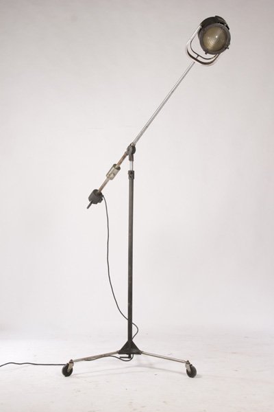 UNUSUAL ADJUSTABLE THEATRE/MOVIE LAMP C.1940: A very unusual labeled and fully adjustable theatre or movie lamp with pistol grip lamp control circa 1940. Labeled as "Giraffe - T.M. & Pats. App. USA, Display Lighting Inc. N.Y.C." Ht: 65" Width: 30