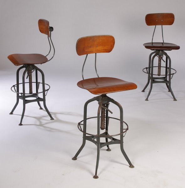 3 Labeled Toledo wood and metal industrial stools: A set of three labeled Toledo & Co, wood and metal industrial stools having adjustable height circa 1950. Perfect for your gourmet kitchen island. Ht: 41" Width: 15.5" Depth: 19"