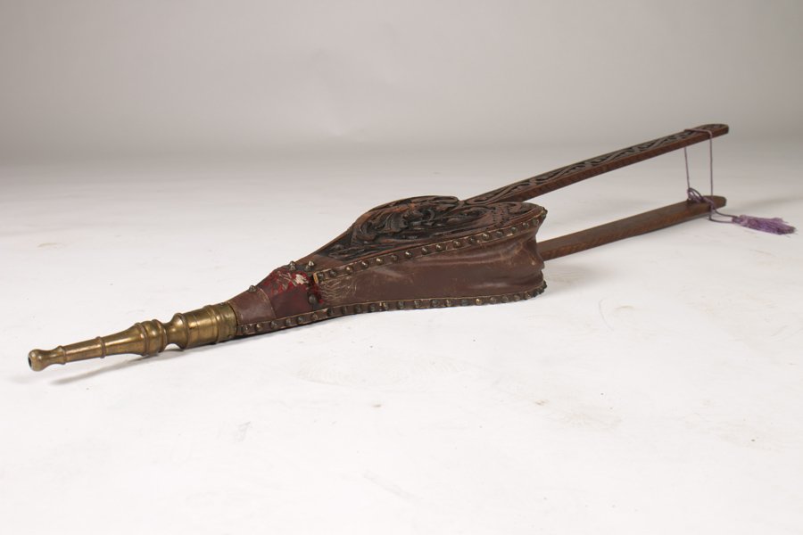 ANTIQUE FIREPLACE BELLOWS CIRCA 1890: An antique fireplace bellows with carved body and brass nozzle circa 1890. Dimensions: Ht: 45" Width: 9.5"