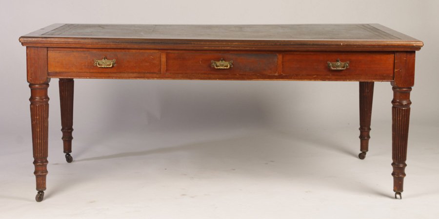 ENGLISH MAHOGANY PARTNERS DESK CIRCA 1890: English mahogany partners desk having inset leather top over six drawers and supported on turned and reeded legs with casters, circa 1890. Ht: 31.5" Width: 73.5" Depth: 41"