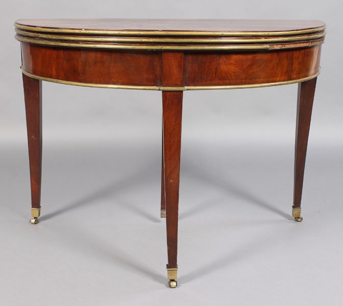 19TH CENT BRONZE MOUNTED TRIPLE FLIP TOP DEMILUNE: A good nineteenth century French directoire bronze mounted triple flip top demilune games table. Supported on tapered legs with bronze sabots and casters. Ht: 31" Width: 44" Depth: 21.75"