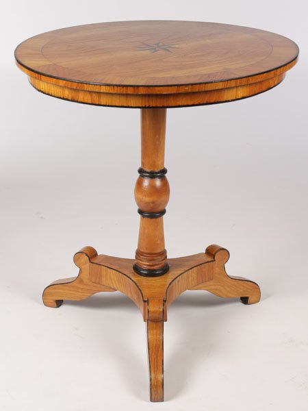 BIEDERMEIER STYLE CENTER TABLE BANDED TOP: A Biedermeier style center table having a central inlaid star decoration and banded top supported on turned pedestal and tripod base. Ht: 30" Dia: 26.5"