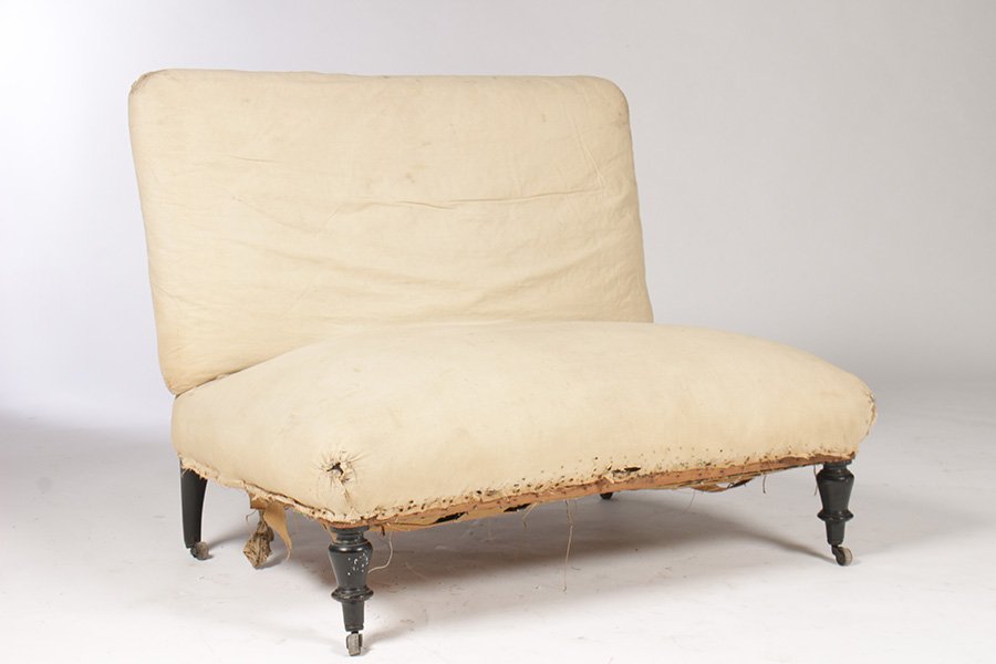 NAP III UPHOLSTERED ARMLESS SETTEE: A Napoleon III upholstered armless settee raised on turned legs circa 1890. Ht: 33" Width: 38" Depth: 28"