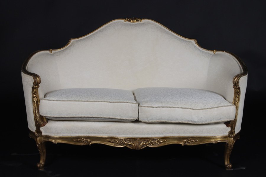 LOUIS XV GILTWOOD CARVED SETTEE LOOSE SEAT: A Louis XV style giltwood carved settee having shaped back and continuous arms over loose cushion seat raised on cabriole legs circa 1930. Ht: 35" Width: 55" Depth: 22"