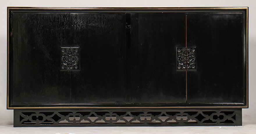 JAMES MONT STYLE VINTAGE EBONIZED SIDEBOARD: A mid century modern James Mont style sideboard having an ebonized cabinet with bronze trimmed border framing four doors. With carved escutcheon, raised on a platform base. Lacking marble top. Ht: 40"