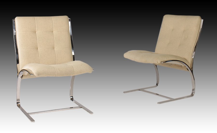 PAIR CREAM CHROME BREUTON LOUNGE CHAIRS C.1960: A pair of labelled Brueton lounge chairs circa 1960. Having a polished chrome frame and cream upholstery. Ht: 34" Width: 23.5" Depth: 25"