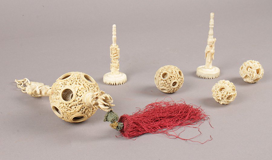 6 PIECE COLLECTION OF ANTIQUE CARVED IVORY ITEMS: Fantastic six piece collection of antique carved ivory items circa 1900. Featuring an awesome hanging puzzle ball (15" with tassel), 3 smaller puzzle balls, and 2 game pieces/stands.