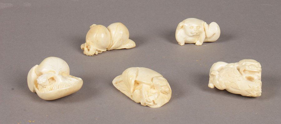 LOT OF 5 JAPANESE IVORY NETSUKE AKITA SIGNED: A grouping of five Japanese ivory netsuke consisting of akita puppy mushrooms, turtle, persimmon, and foo dogs all bearing signatures. Ht: 2" Width: 1" Depth: 1" (average)