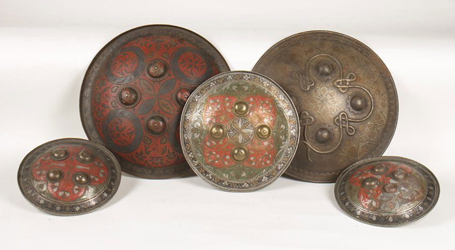 5 MIDDLE EASTERN ANTIQUE WARRIOR SHIELDS: A lot of five decorated middle eastern antique warrior shields circa 1900. Ranging from 8.5" to 14.5"