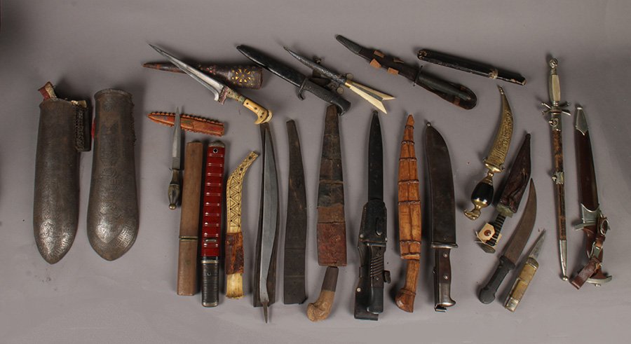 LOT OF 23 DAGGERS INCLUDING NAZI & MIDDLE EASTERN: An amazing collection of twenty three nineteenth to mid twentieth century vintage and antique daggers from around the world. Including a Nazi dagger, along with two middle eastern antique armour arm p