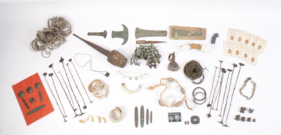 LARGE LOT OF TRIBAL CURRENCY AND CRATE: A large lot of mostly metal African tribal currency consisting with wooden shipping crate from Liberia with Iran currency staffs.