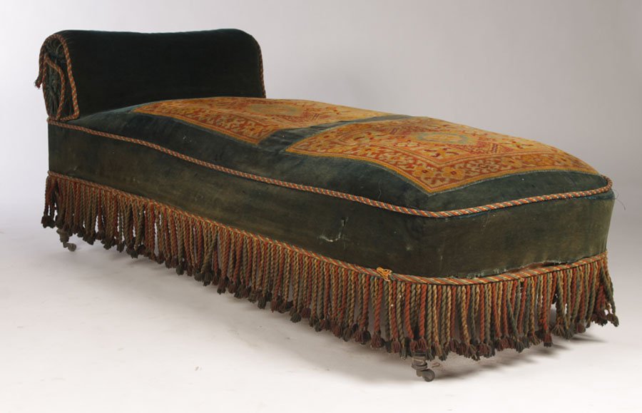 19TH C. MOORISH INSPIRED CHAISE LOUNGE MOHAIR: Nineteenth century Moorish inspired chaise lounge upholstered in mohair and rug squares with braided trim all raised on turned legs circa 1890. Ht: 27" Width: 69" Depth: 28"