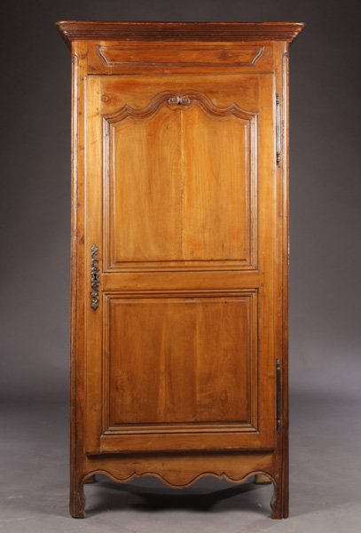 FRENCH 18TH C. CARVED WALNUT CUPBOARD: A French eighteenth Century carved walnut cupboard having stepped cornice over single panel decoration flanked by molded champfered corners. Raised on straight legs. Ht: 75" Width: 38.5" Depth: 24"