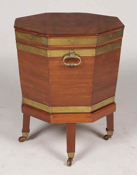 ANTIQUE ENGLISH OCTAGONAL CELLARETTE: Antique English octagonal cellarette having lift top and brass banding raised on legs with brass casters. Ht: 22" Width: 18" Depth: 18"