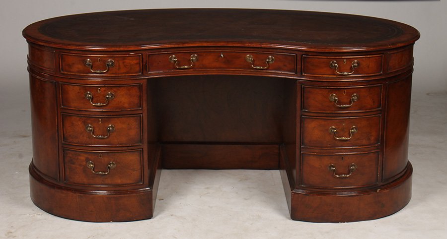 ENGLISH GEORGIAN STYLE PARTNERS DESK LEATHER TOP: English Georgian style kidney shaped partners desk having inset leather top over a set of drawers and faux front doors. Ht: 32" Width: 71" Depth: 41"